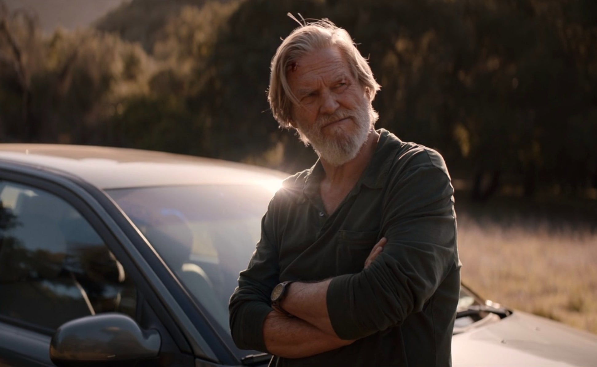 Jeff Bridges leaning on the hood of a car in Episode 3 of The Old Man