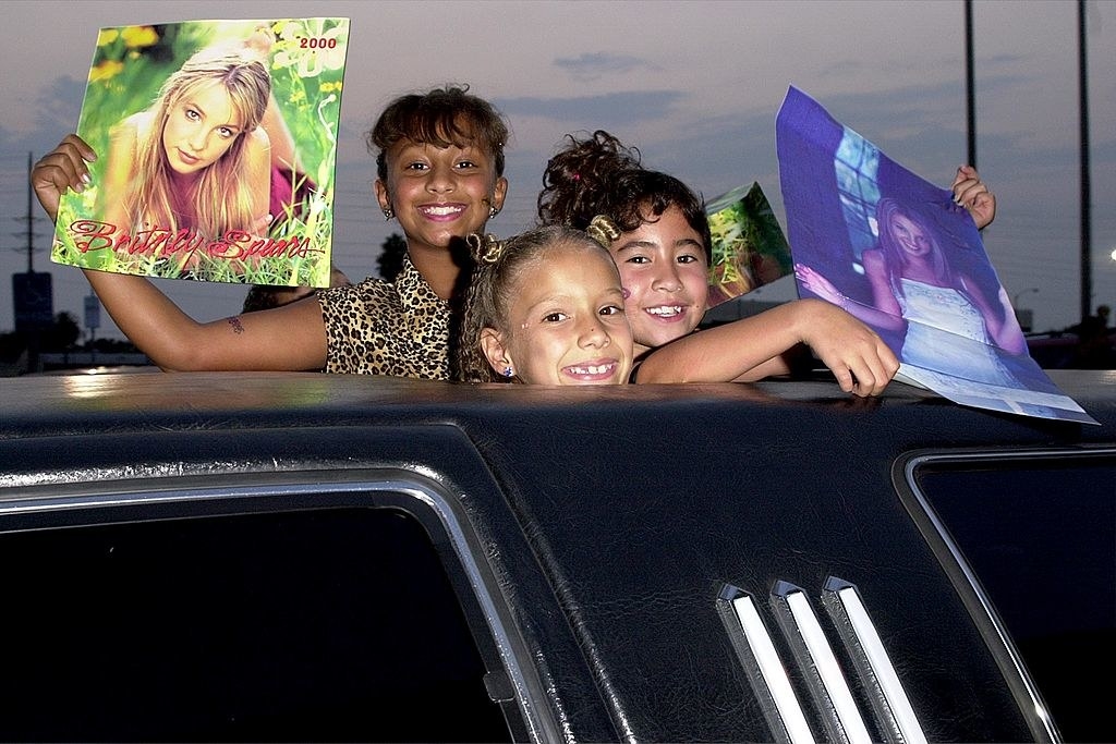 young girls in a limo with britney posters
