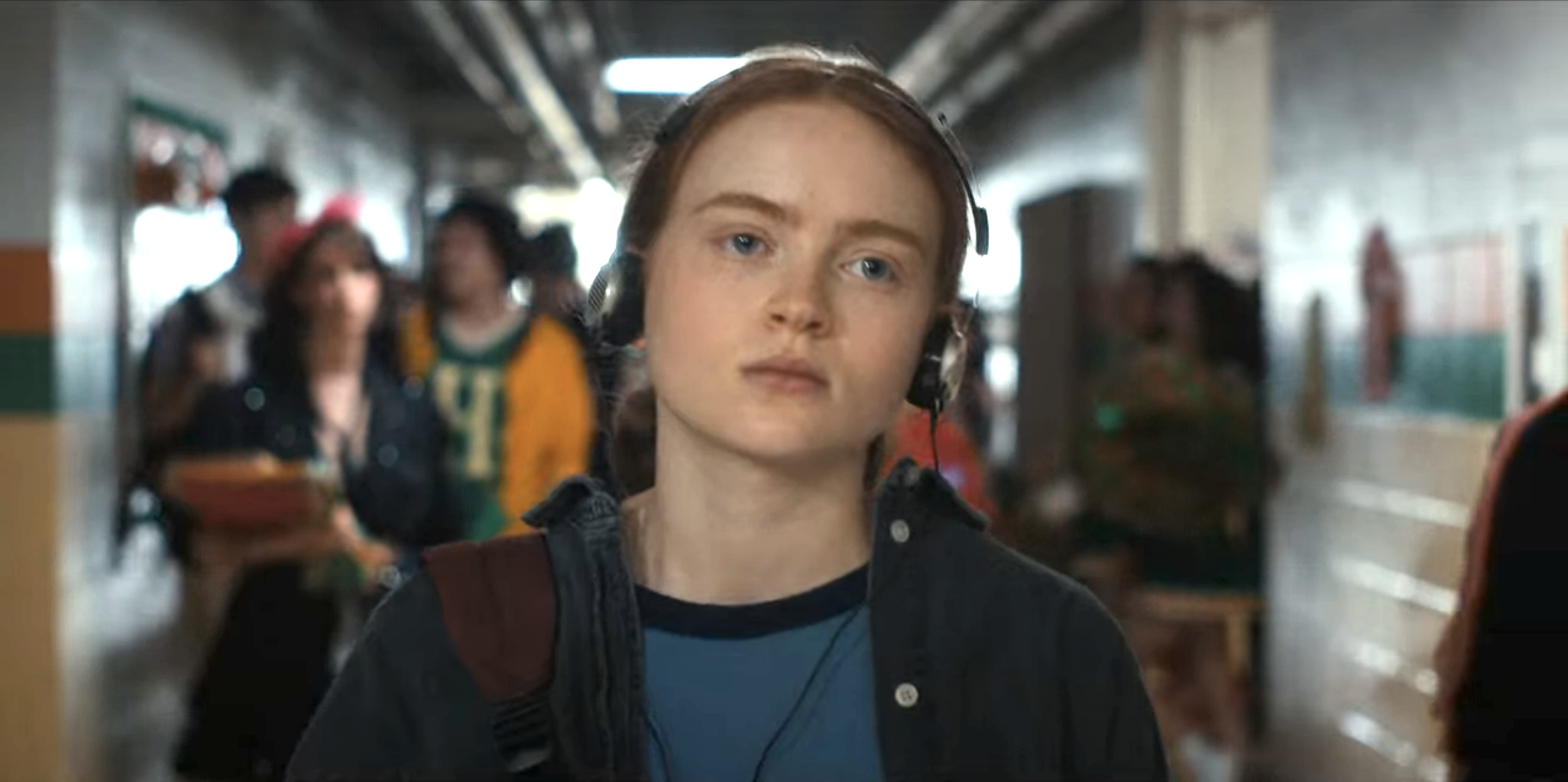 Max in the school hallway with headphones