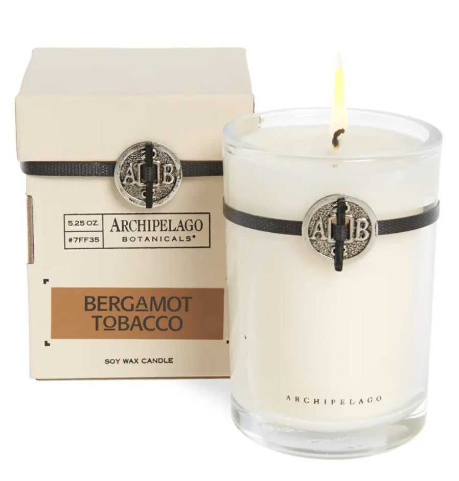 The bergamot tobacco candle in glass jar with AB medallion at top of jar