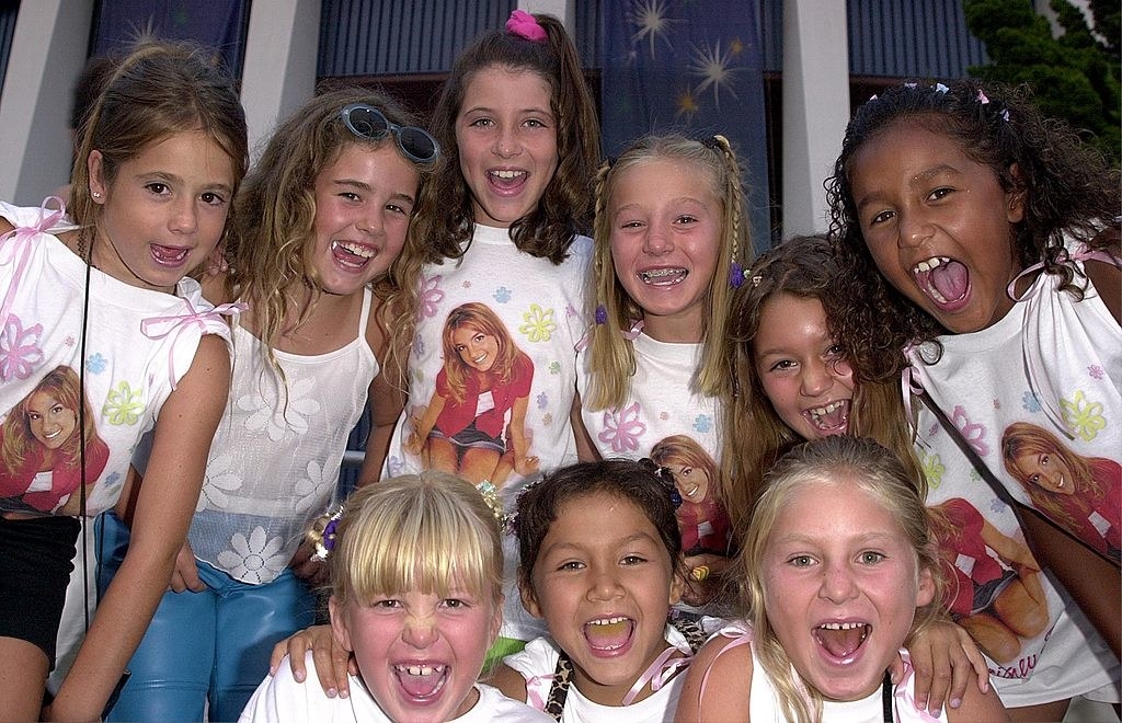 a group of young girls wearing britney shirts