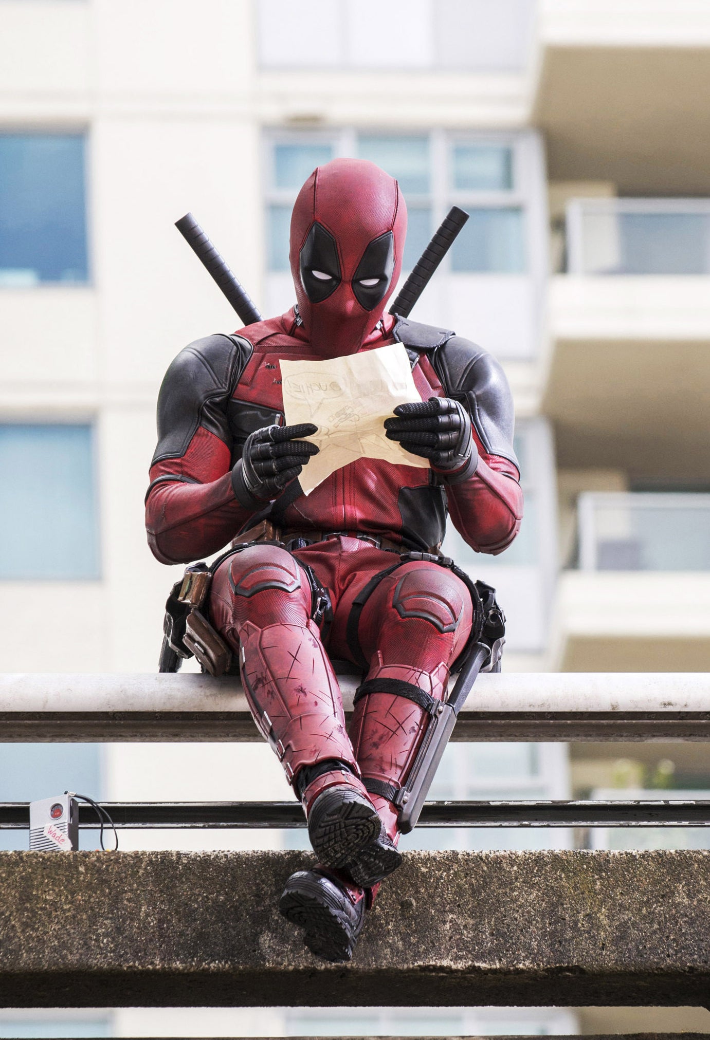 Ryan Reynolds as Wade/Deadpool inspects a piece of paper