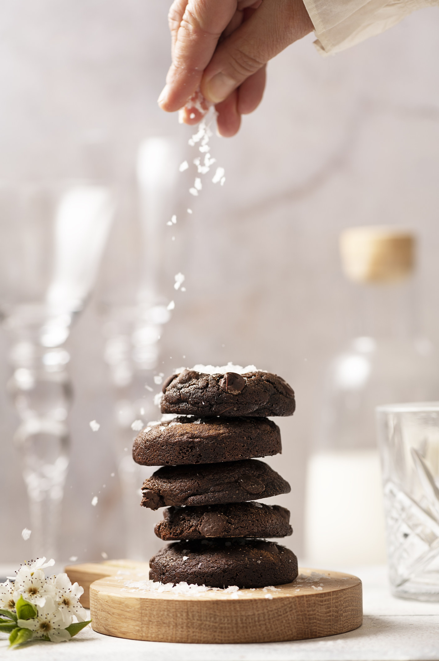 course salt being sprinkled on chocolate cookies