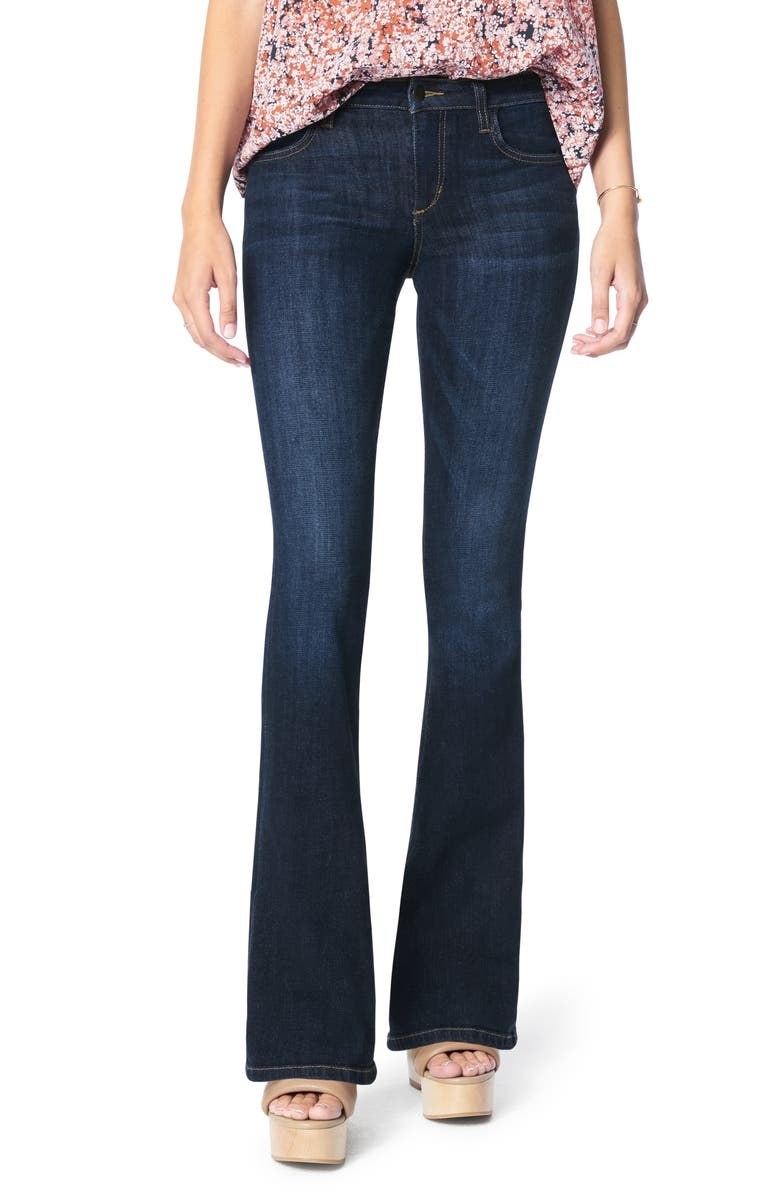 Model wearing dark wash boot-cut jeans