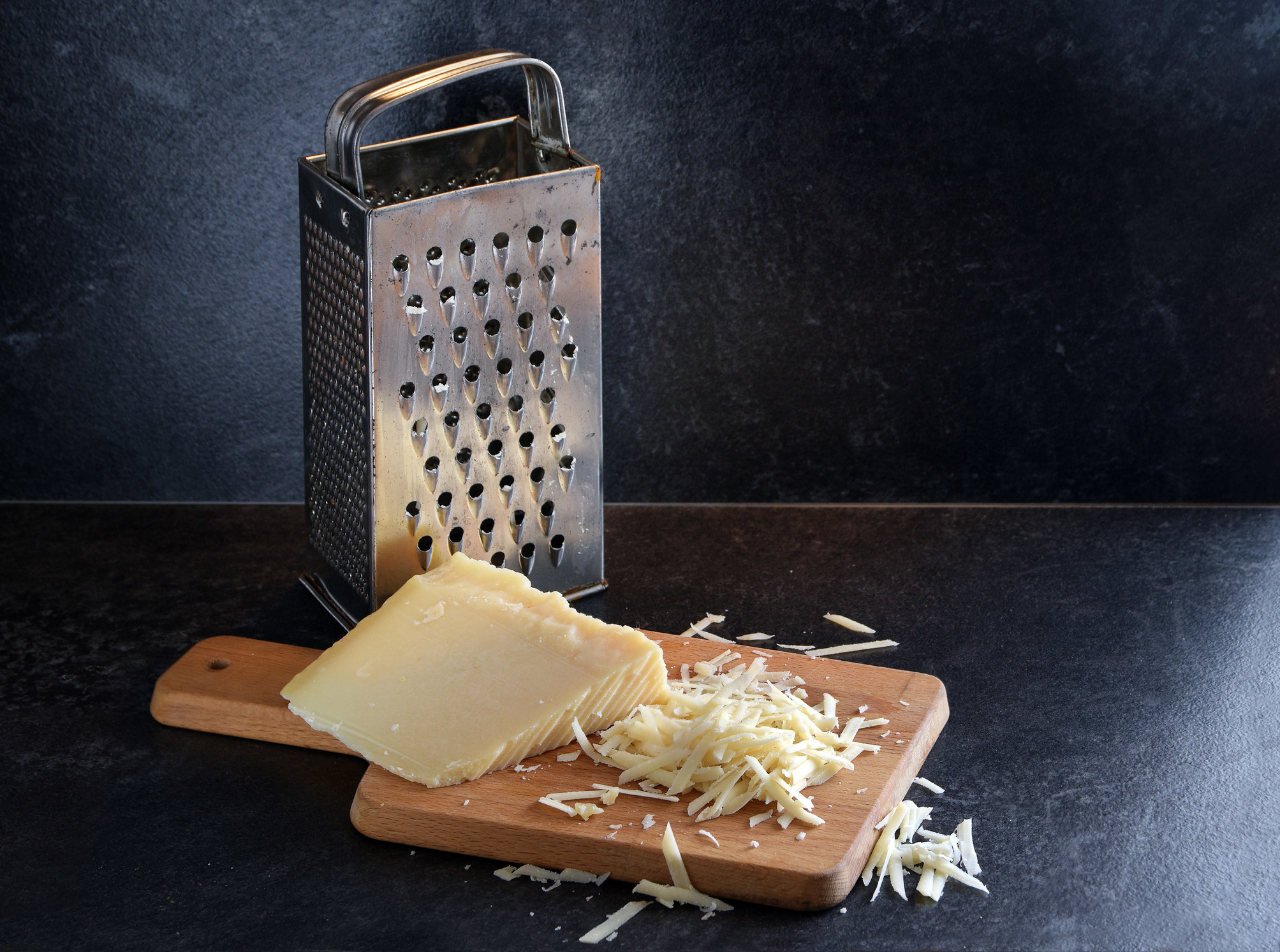 cheese next to a grater