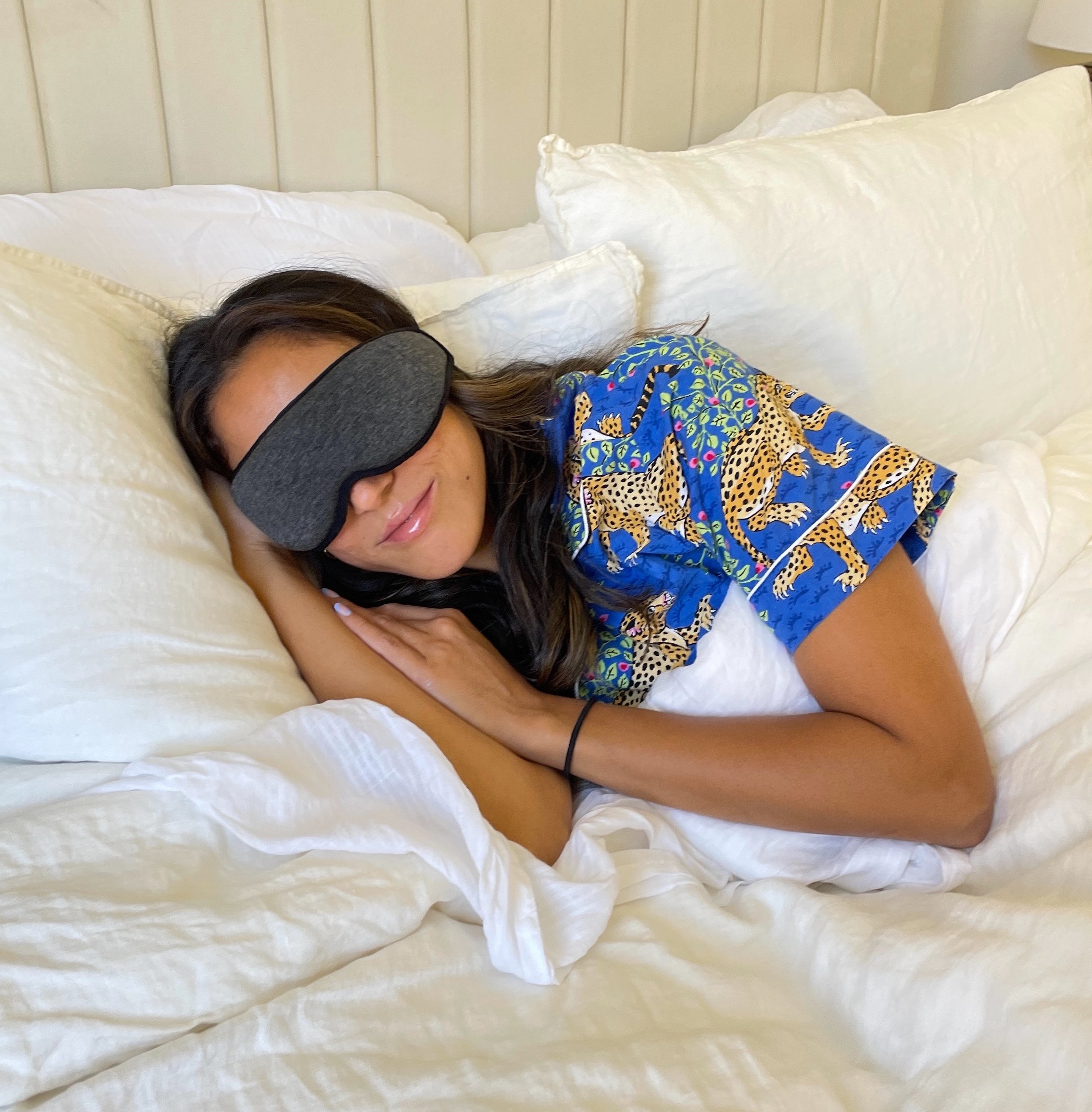 Jasmin in bed wearing the gray mask