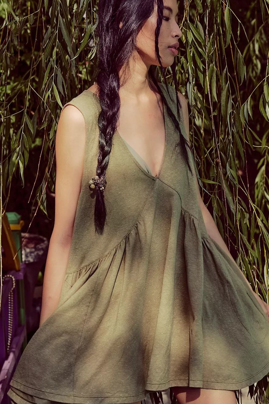 model wearing olive green flowing mini dress