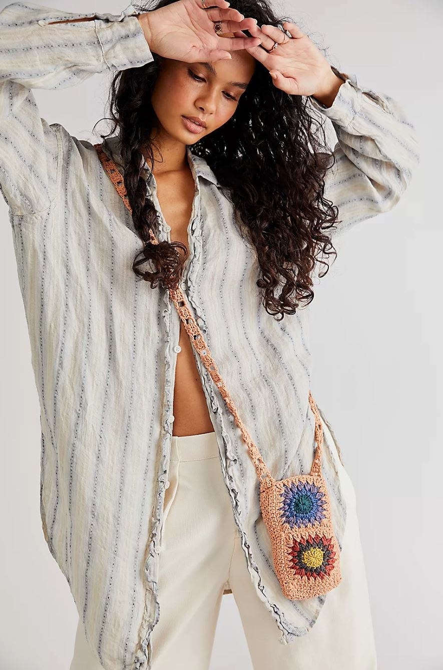 model wearing mini crochet crossbody