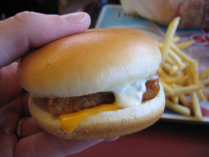 A hand holding a Filet-O-Fish burger