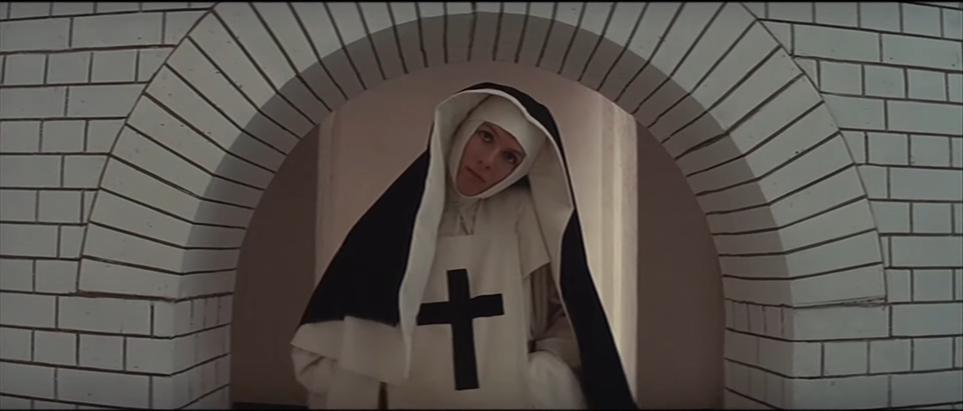 A nun tilting her head beneath an arch in &quot;The Devils&quot;
