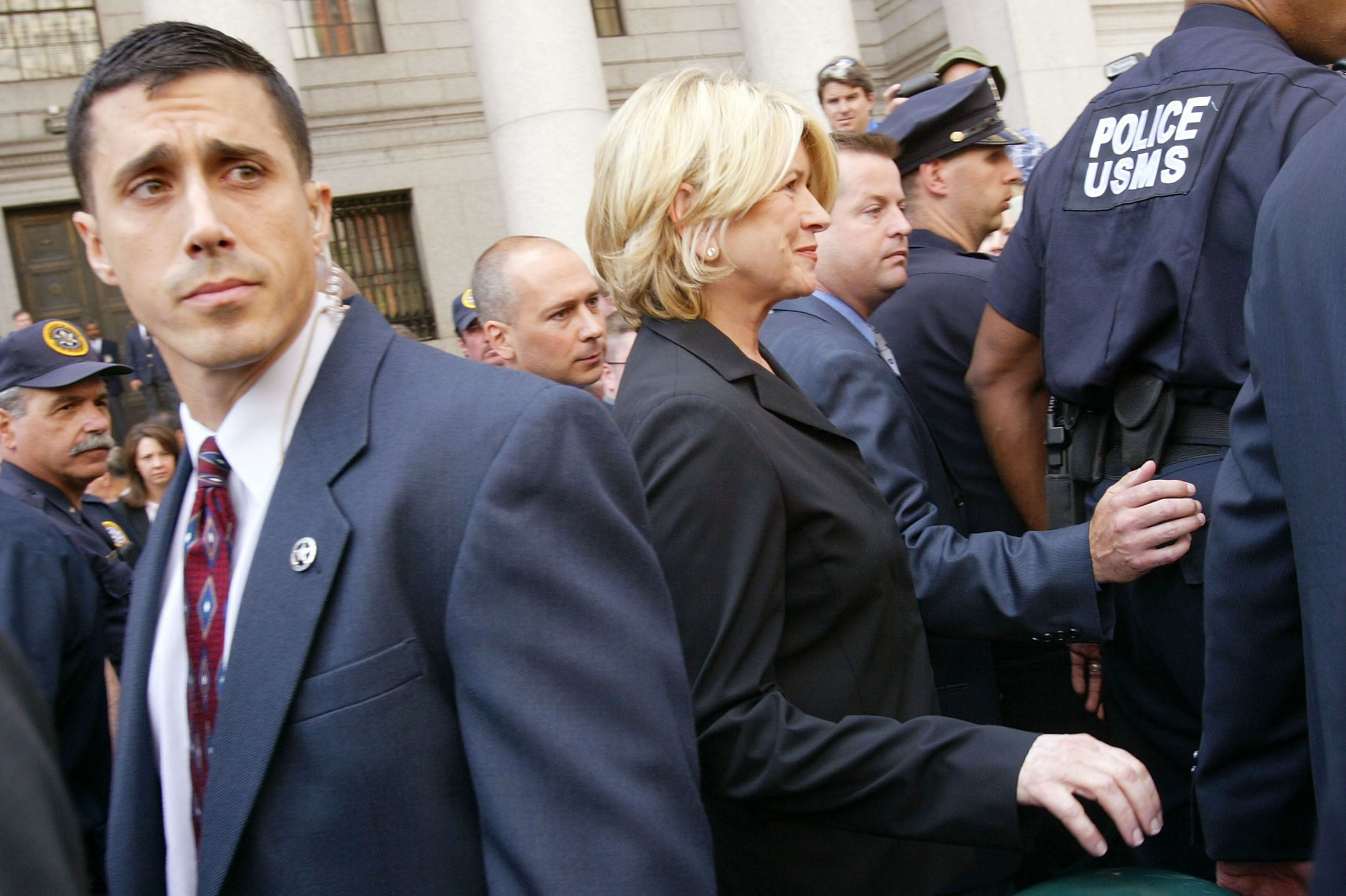 Martha Stewart escorted by police