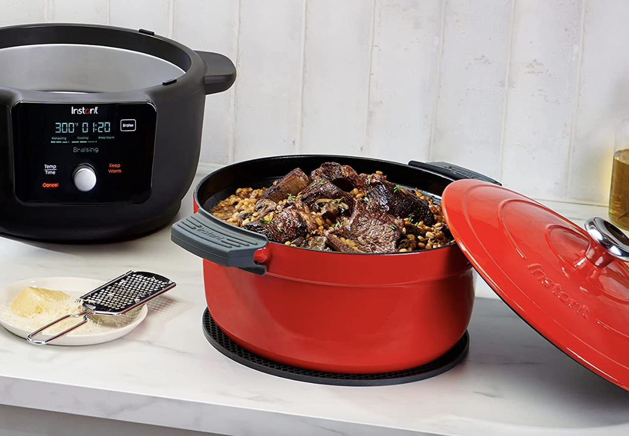 The red Instant Pot Dutch oven with food inside it