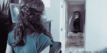 woman watching ghost boy run down hallway