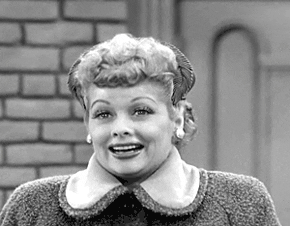 Lucille Ball sighing and smiling in I Love Lucy
