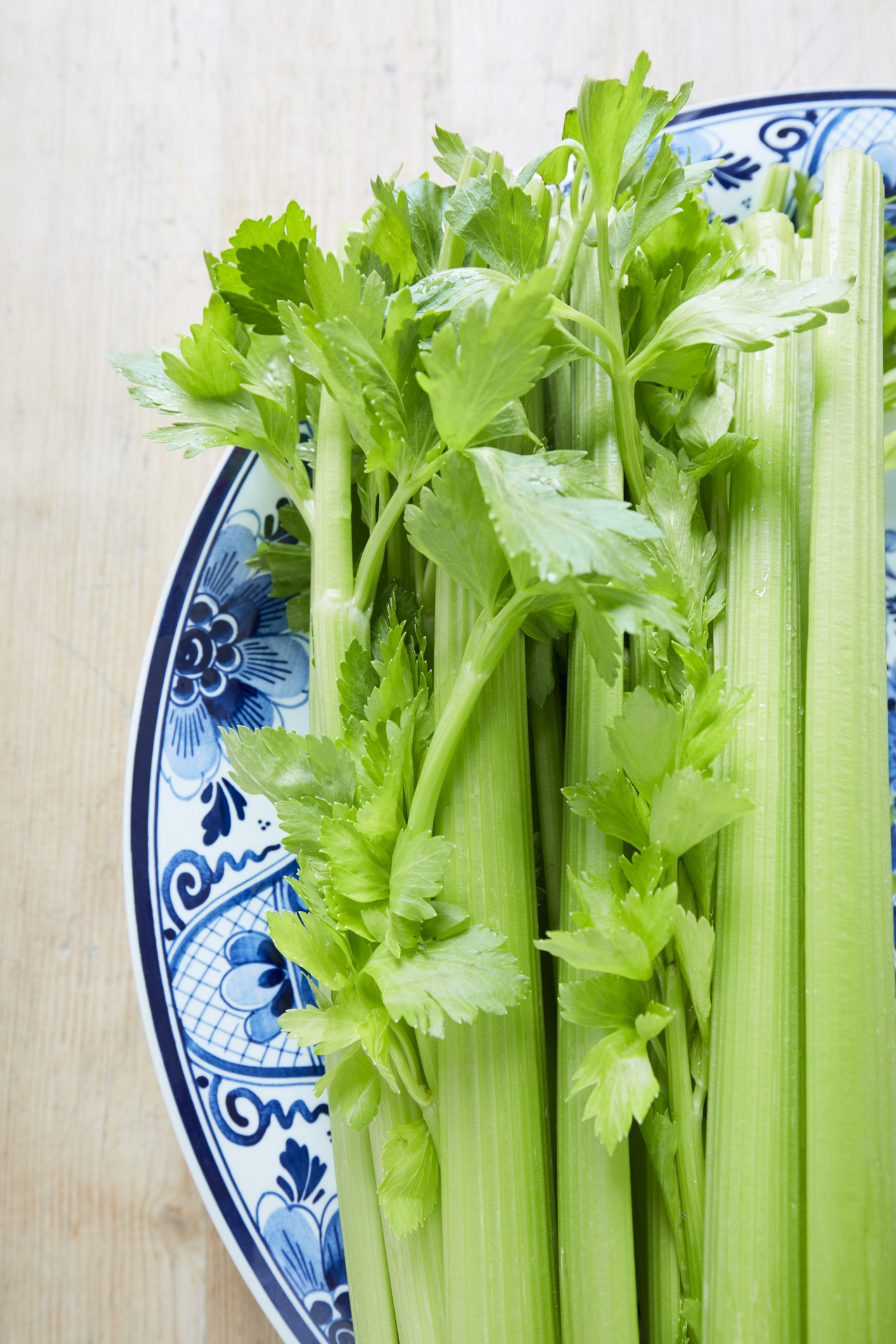 Raw celery sticks on a plate.