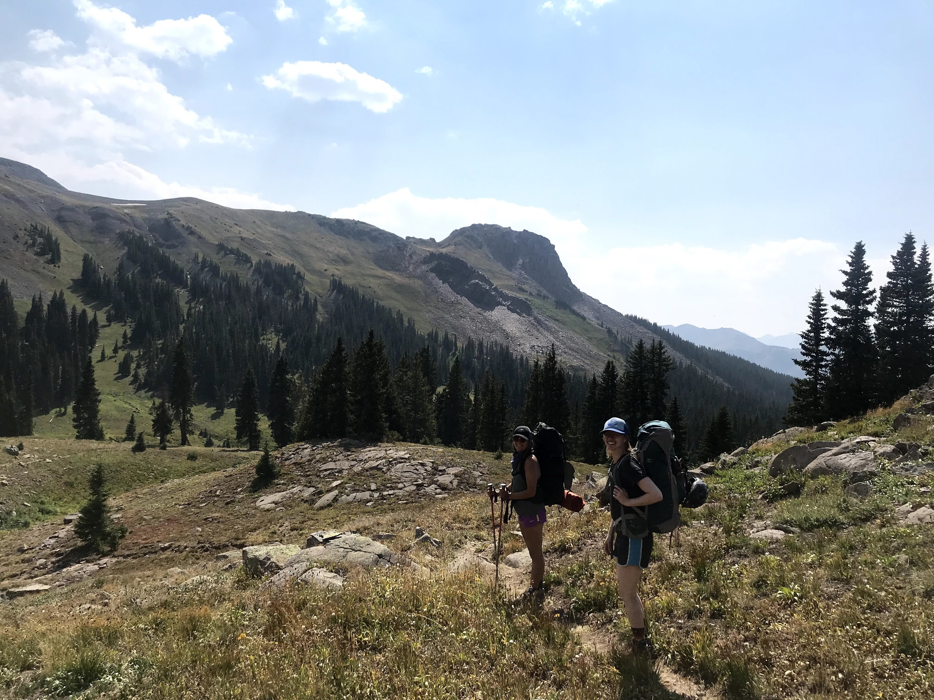 Two women hiking with backpacks on