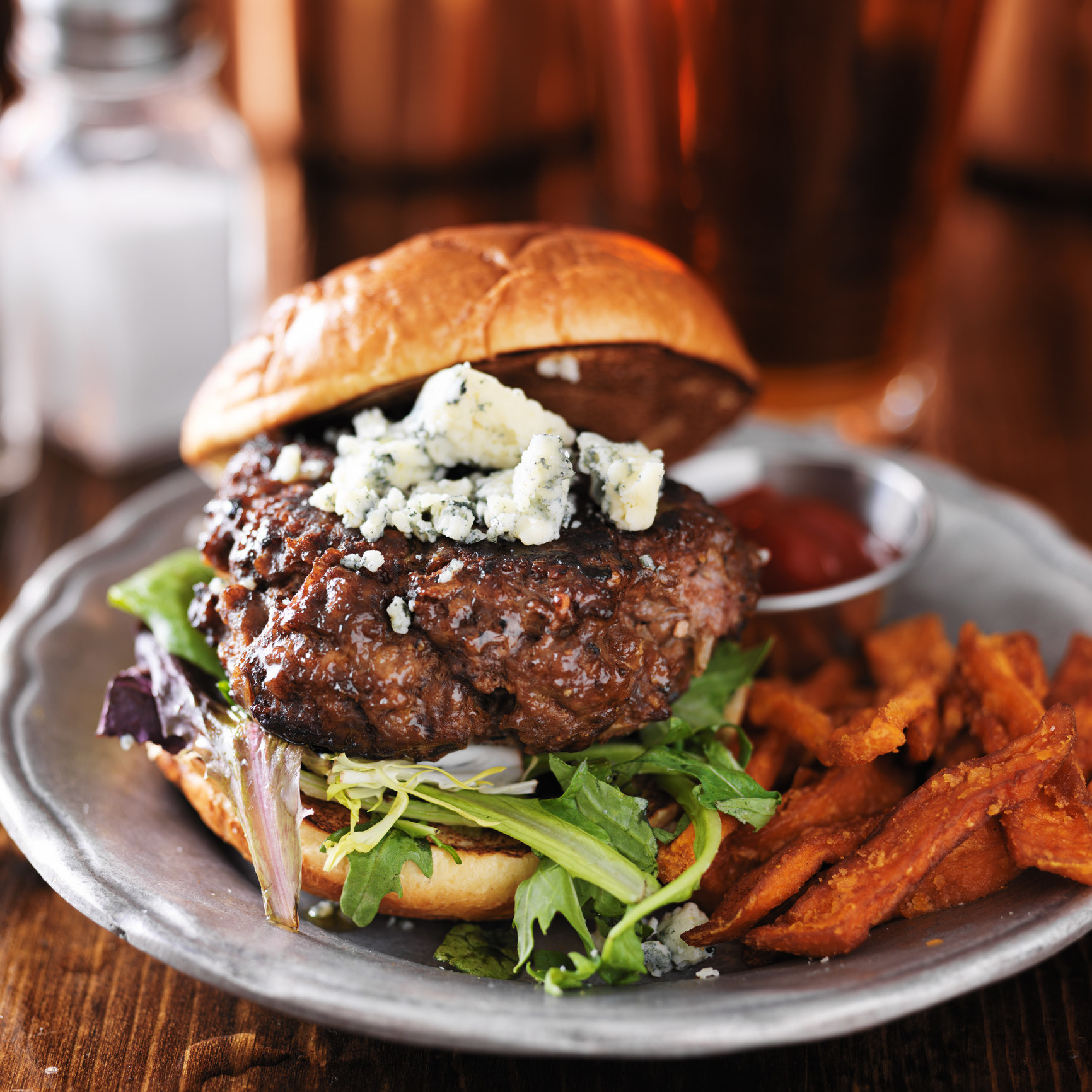 A gourmet burger with blue cheese