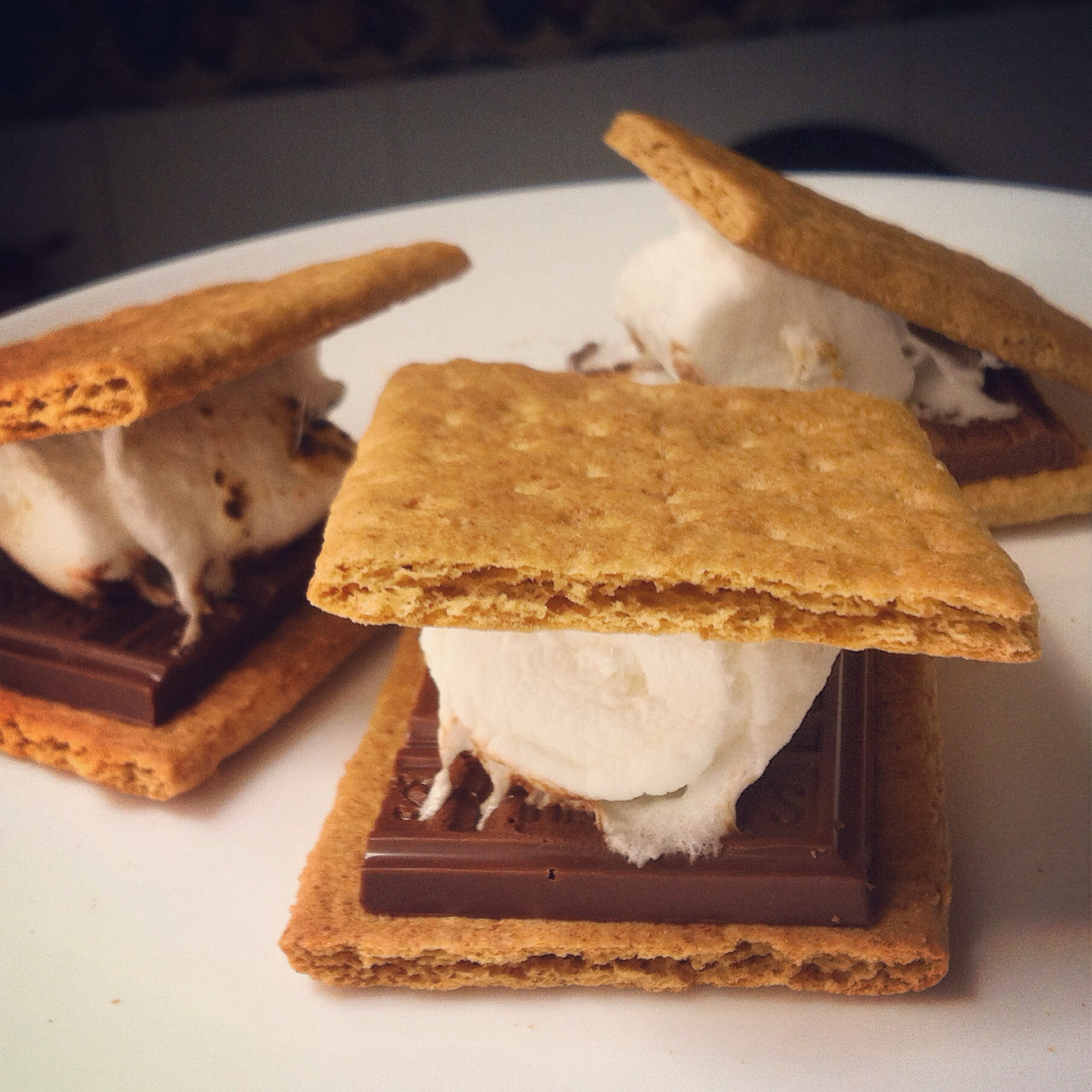 Three s&#x27;mores on a plate.