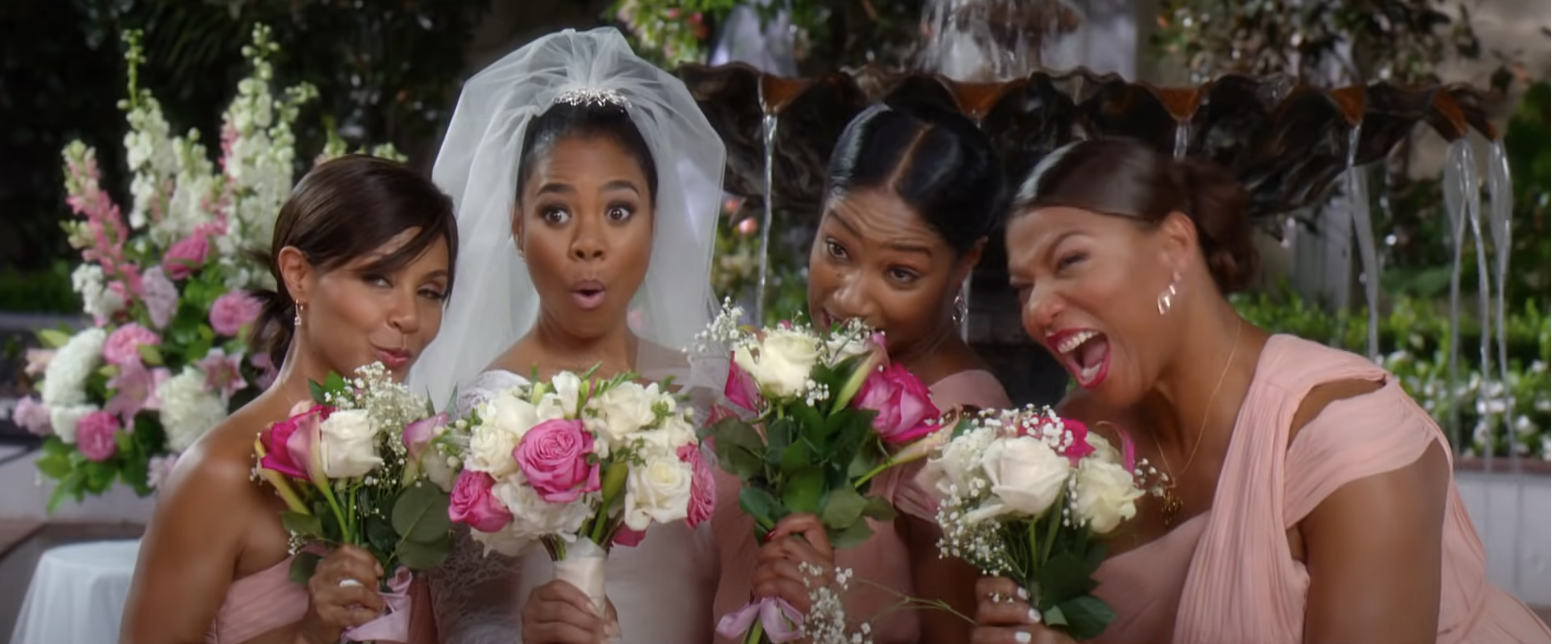 A bride and three bridesmaids pulling faces