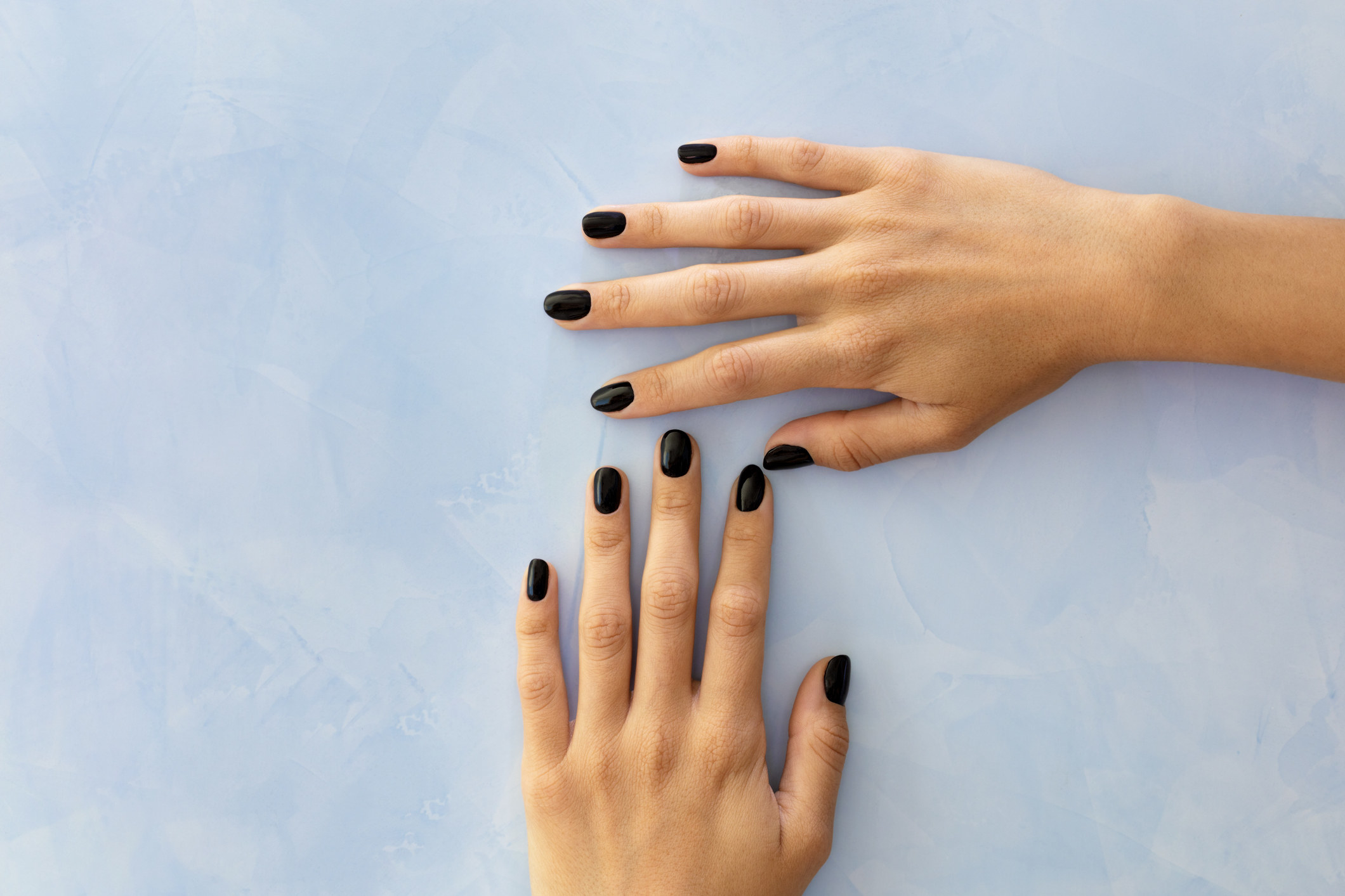 black nail polish on a person&#x27;s hands