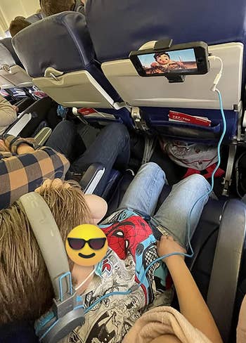 a reviewer's child watching cartoons with the phone mounted on a seat