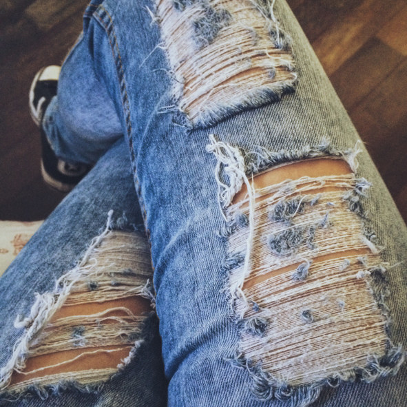 a person&#x27;s ripped jeans