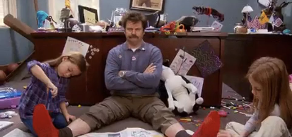 a man looking frazzled in a messy office with two kids around him