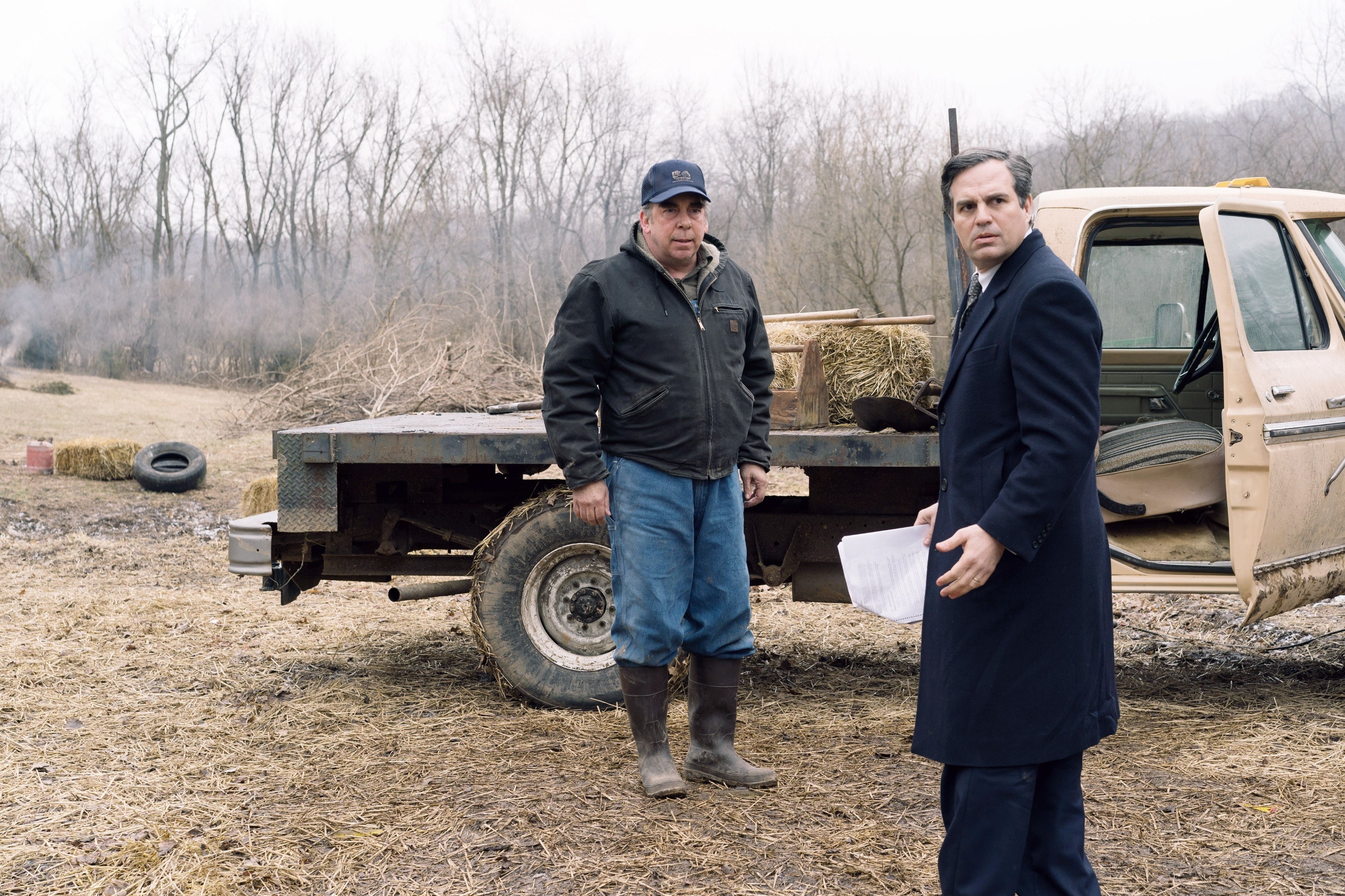 Bill Camp and Mark Ruffalo stand by a truck in a field