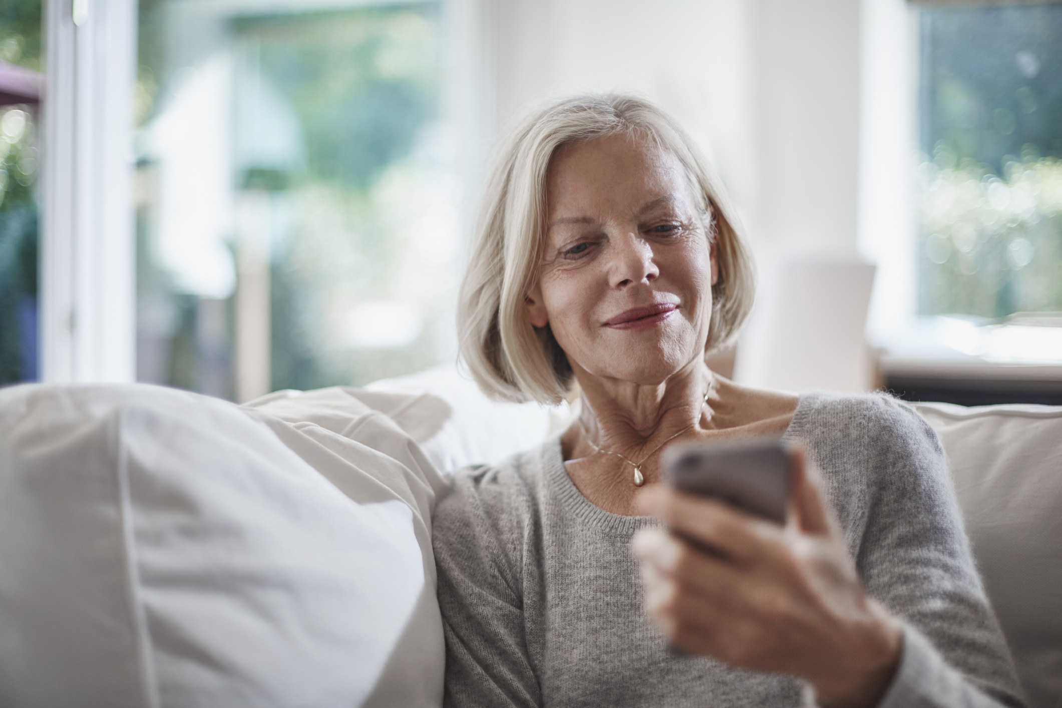 an old lady looking at a phone