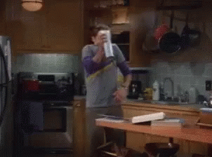 Gif of Jim Parsons as Sheldon on The Big Bang Theory spraying lysol