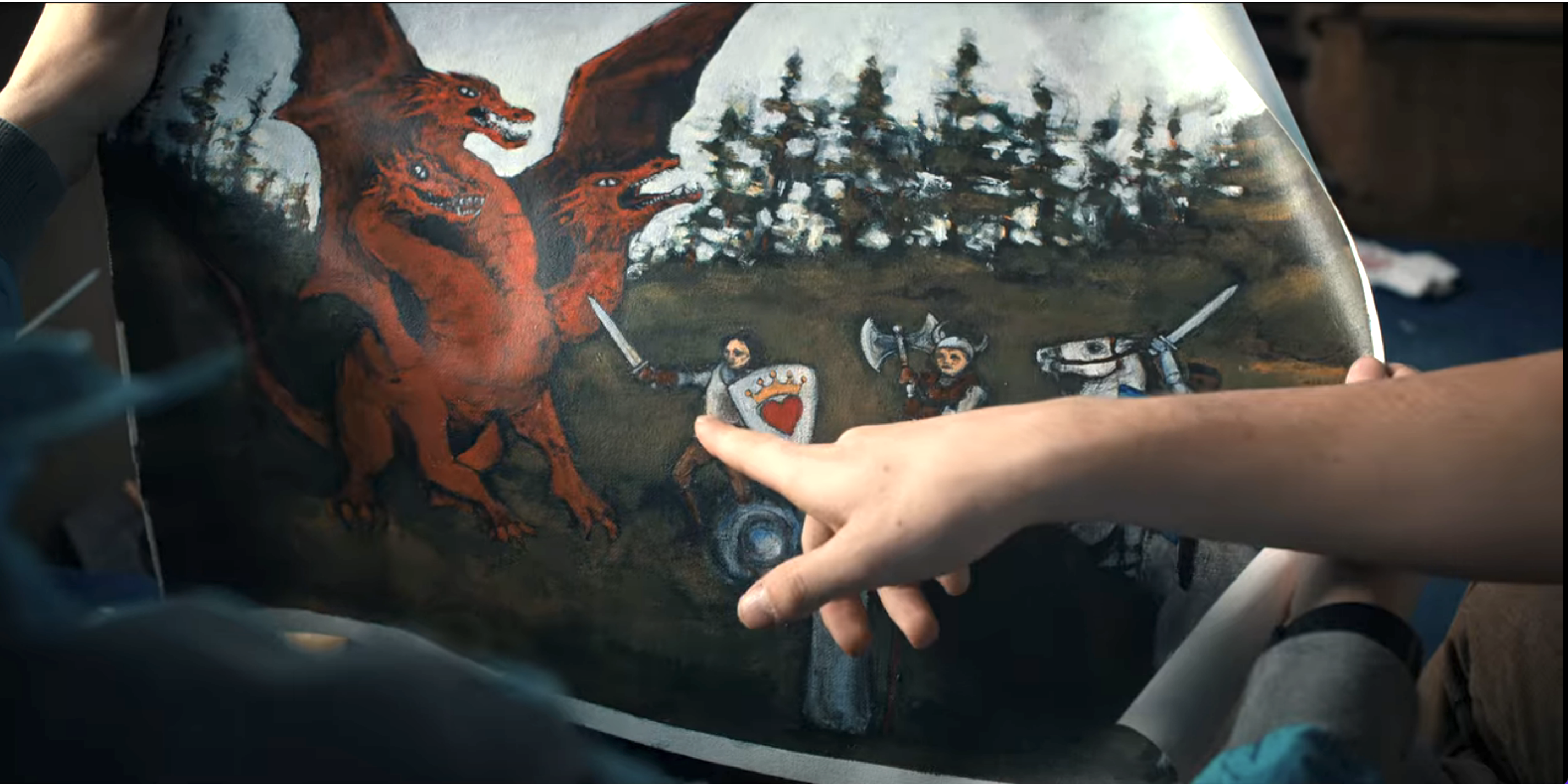 someone pointing to the dragon in the painting