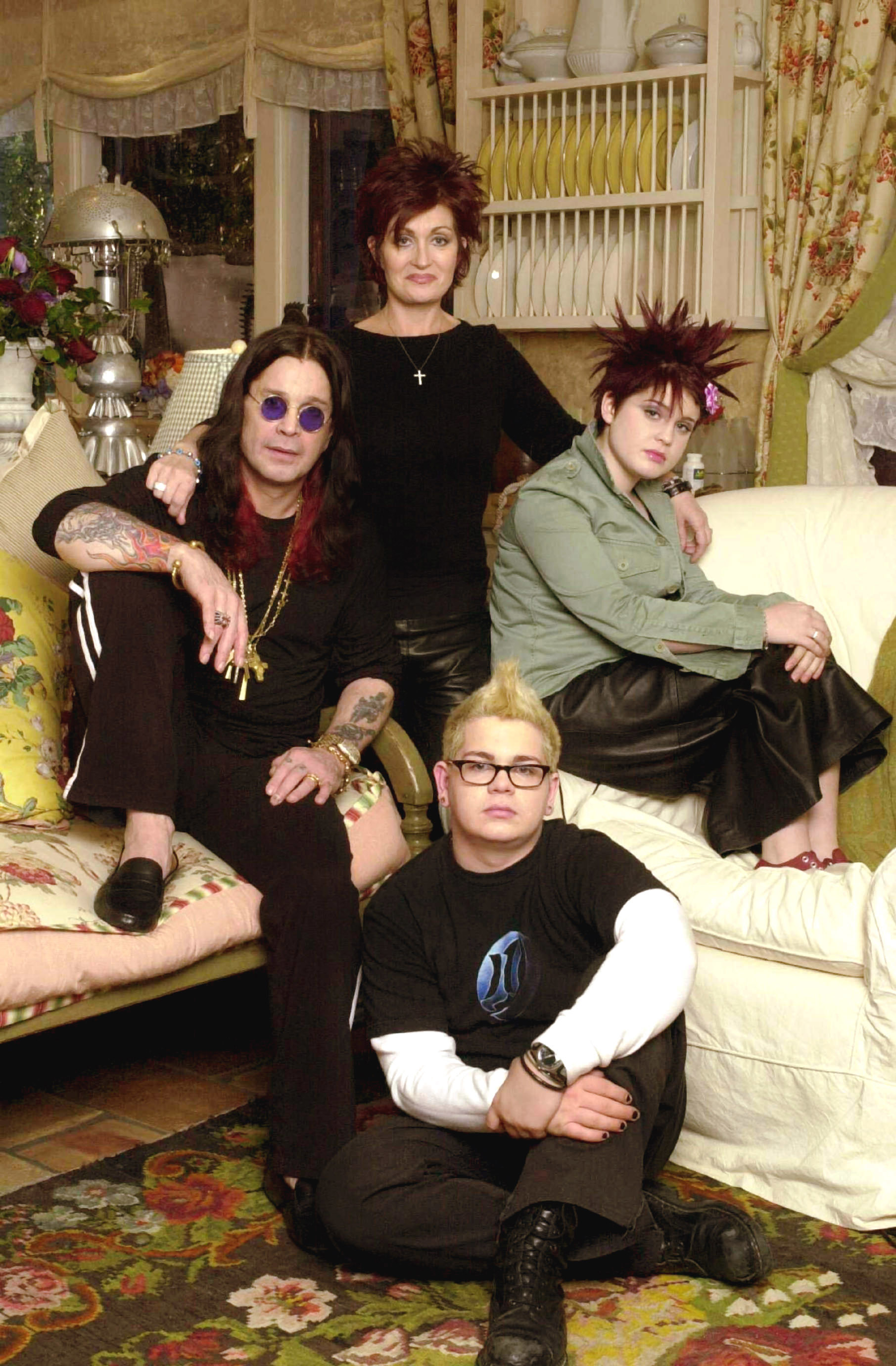 Ozzy and his family sitting or standing together