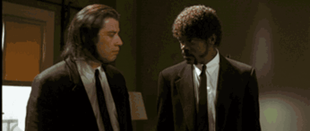 John Travolta as Vincent and Samuel L Jackson as Jules pointing there guns up in &quot;Pulp Fiction&quot;