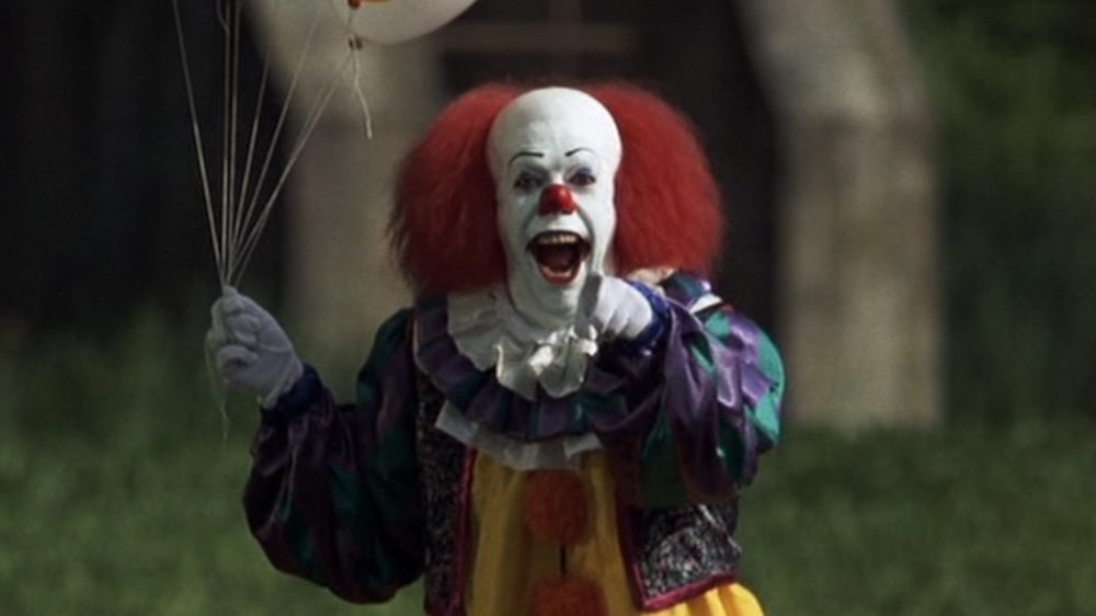 Tim Curry as Pennywise pointing at the camera in &quot;It&quot;