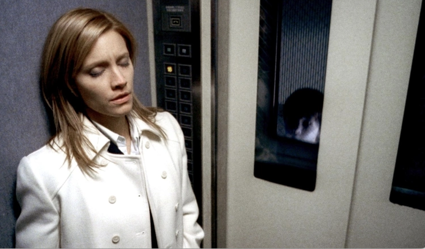 Kadee Strickland as Susan while one of the children is at the window of there door in &quot;the Grudge&quot;