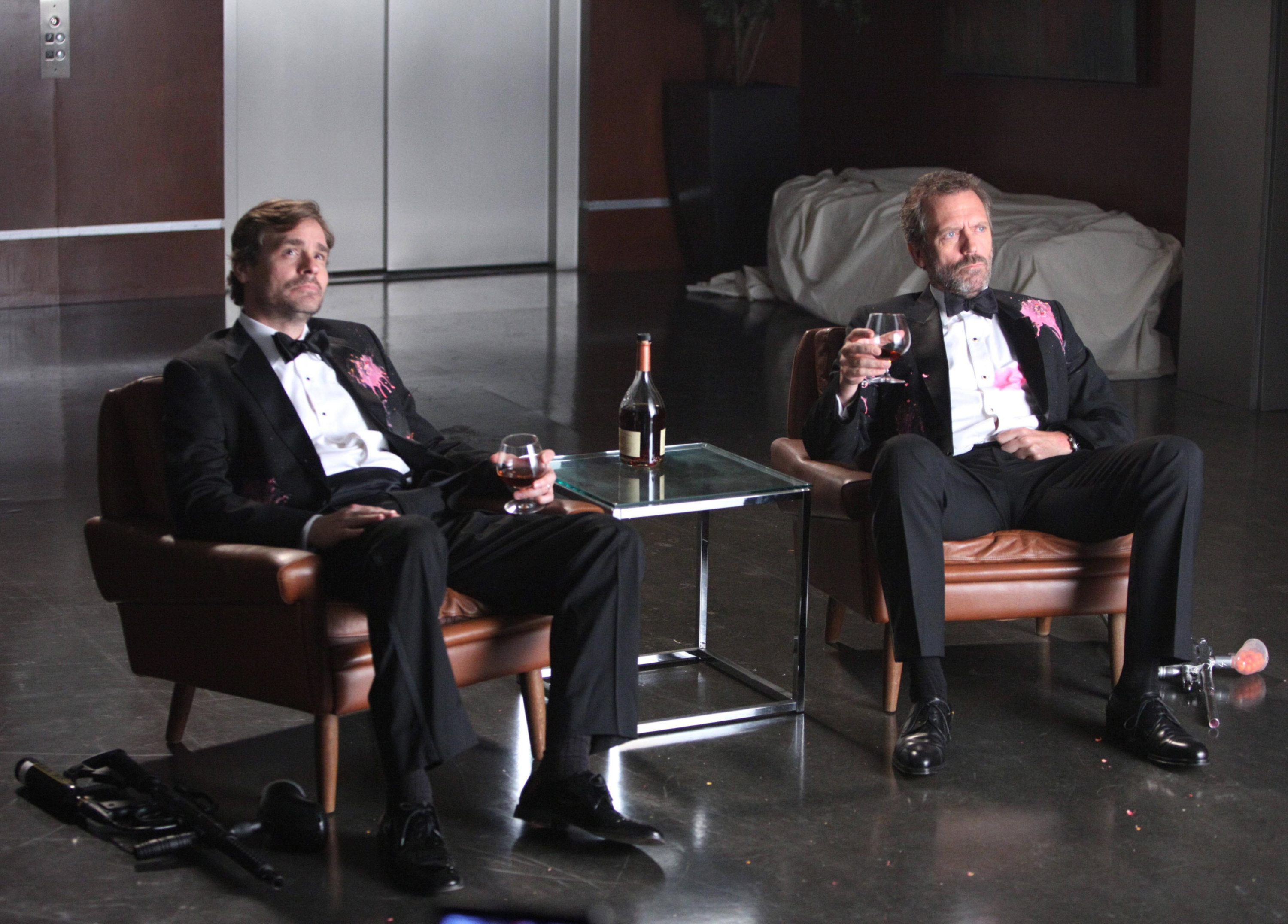 two of the characters drinking in an office
