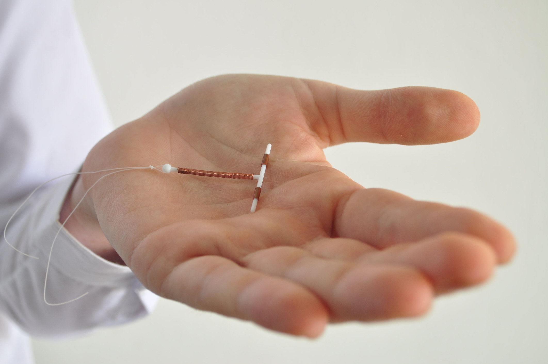 hand holding an IUD