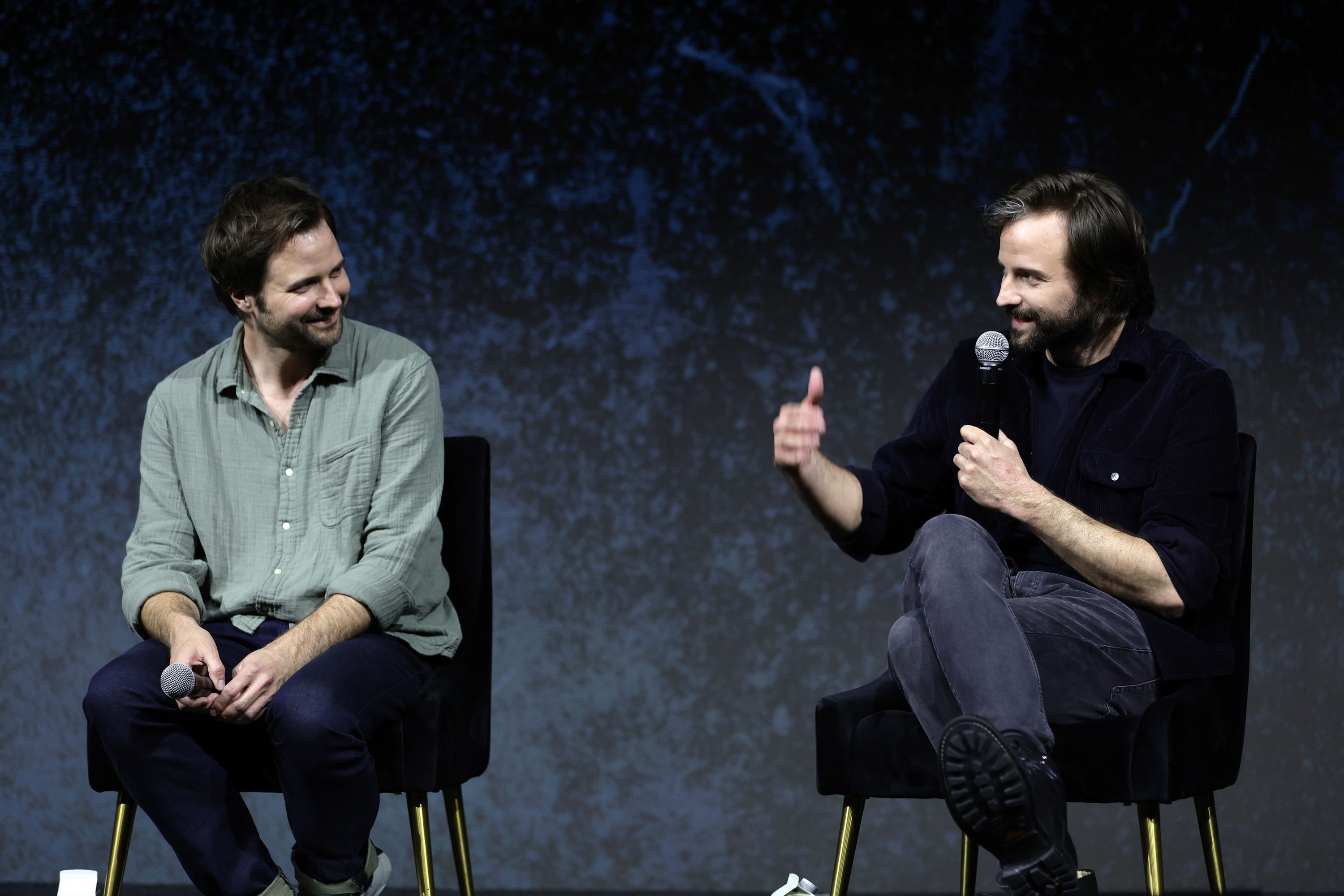 The Duffer brothers talking on stage at a conference