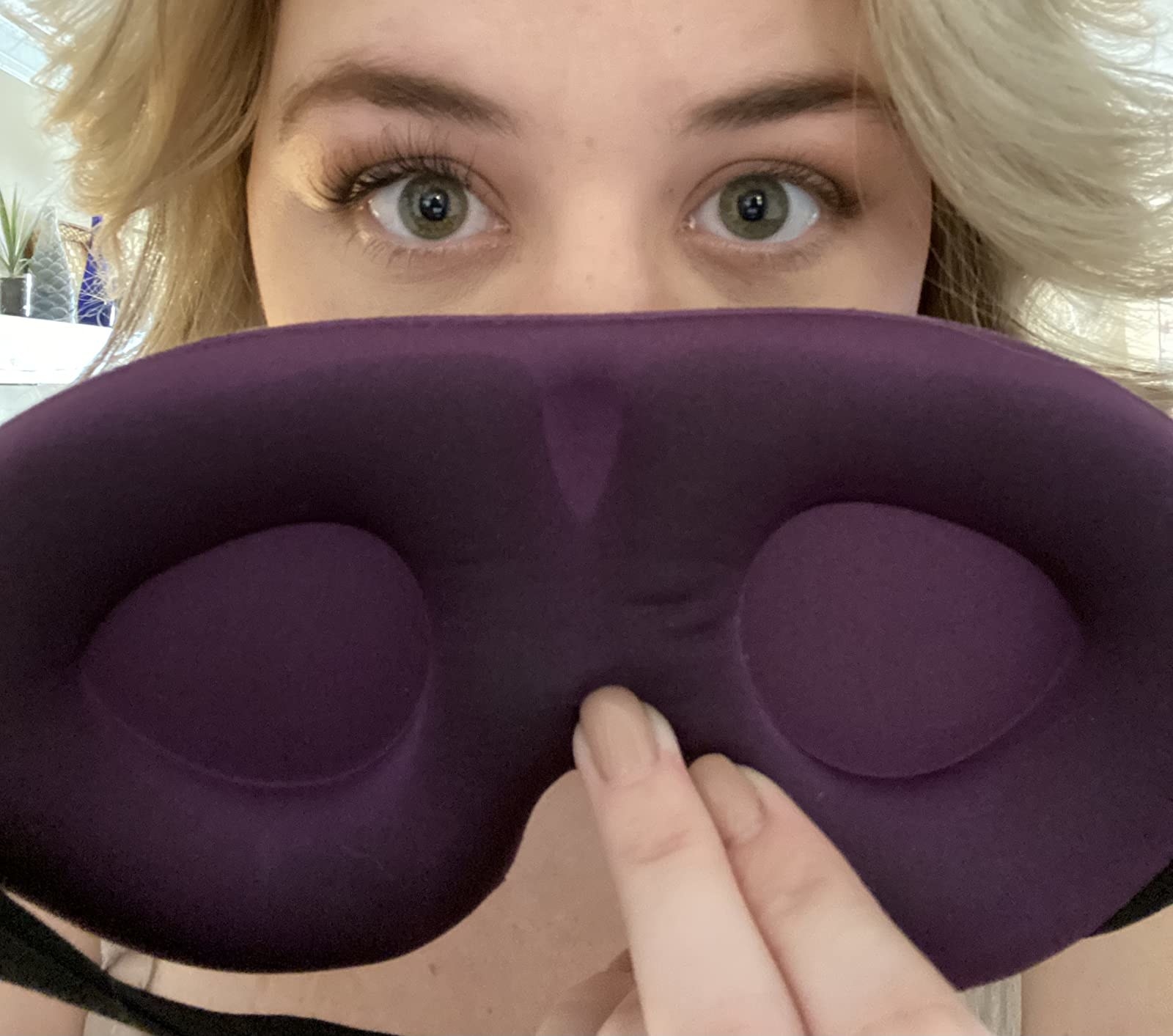 Reviewer holding purple sleep mask