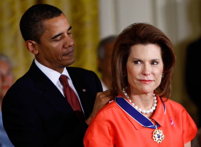 President Obama placing the medal around a woman&#x27;s neck