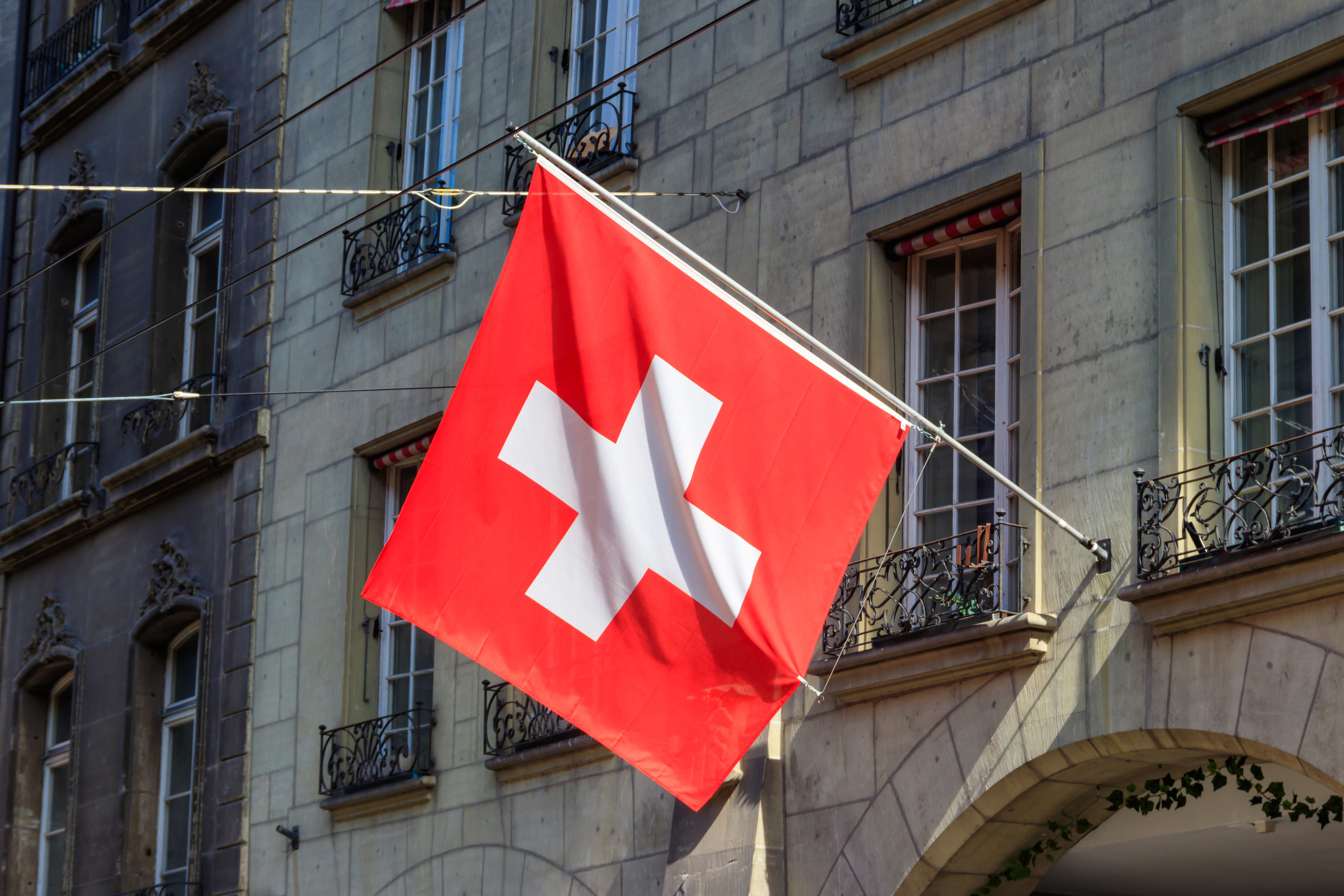 Swiss flag flying outside a building