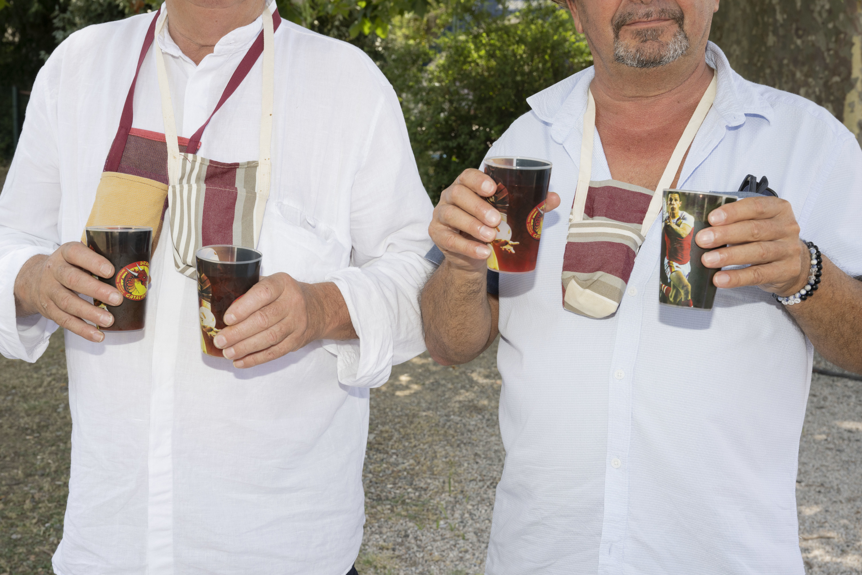 Two men holding beverages during the festival