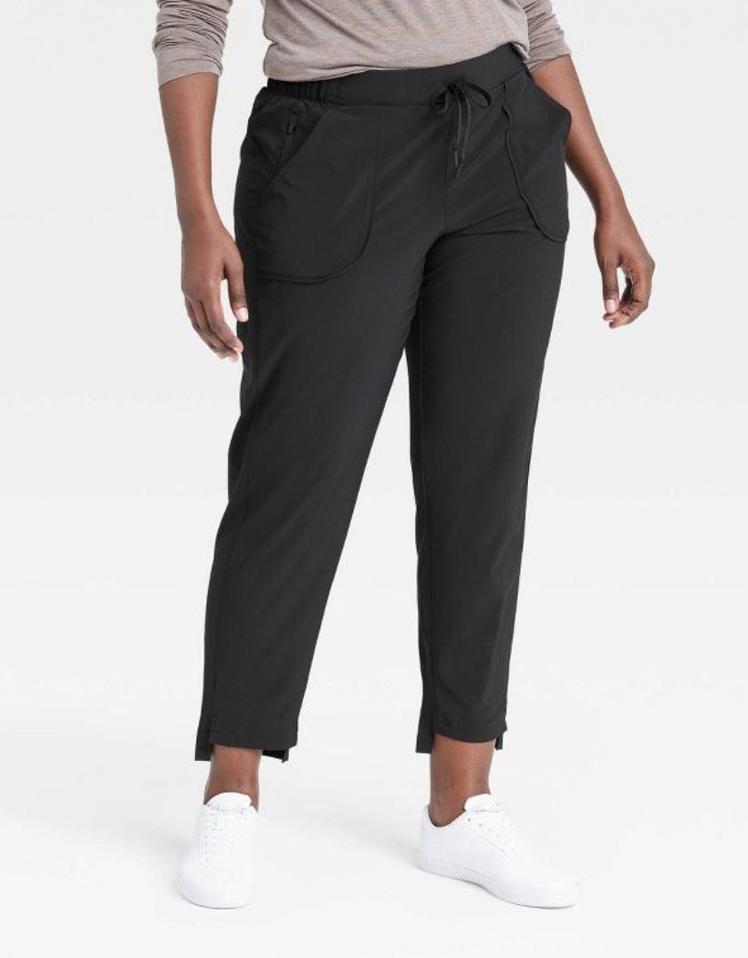 model wearing black tapered stretch woven pants