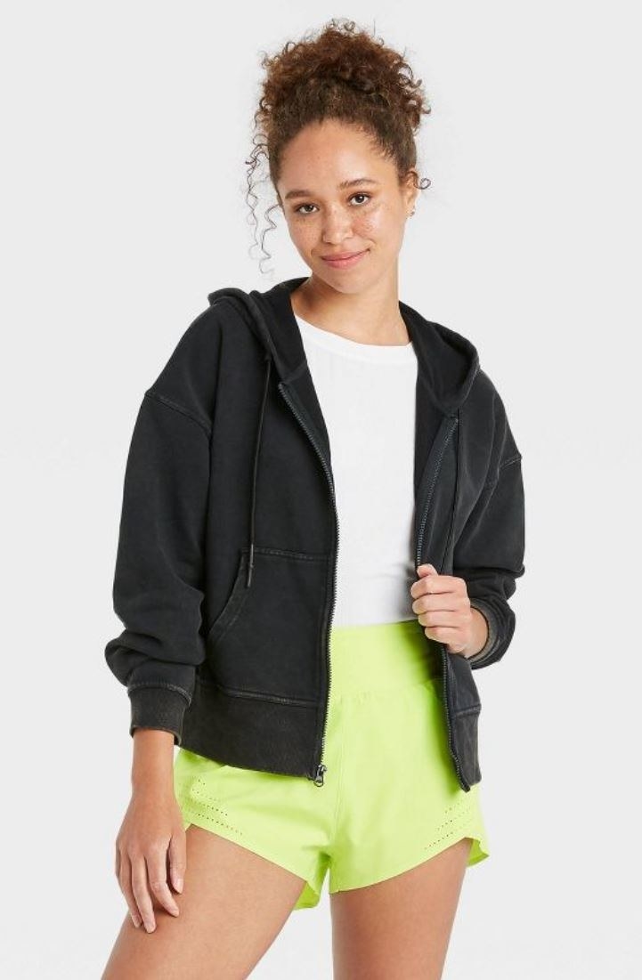 model wearing black zip up hoodie