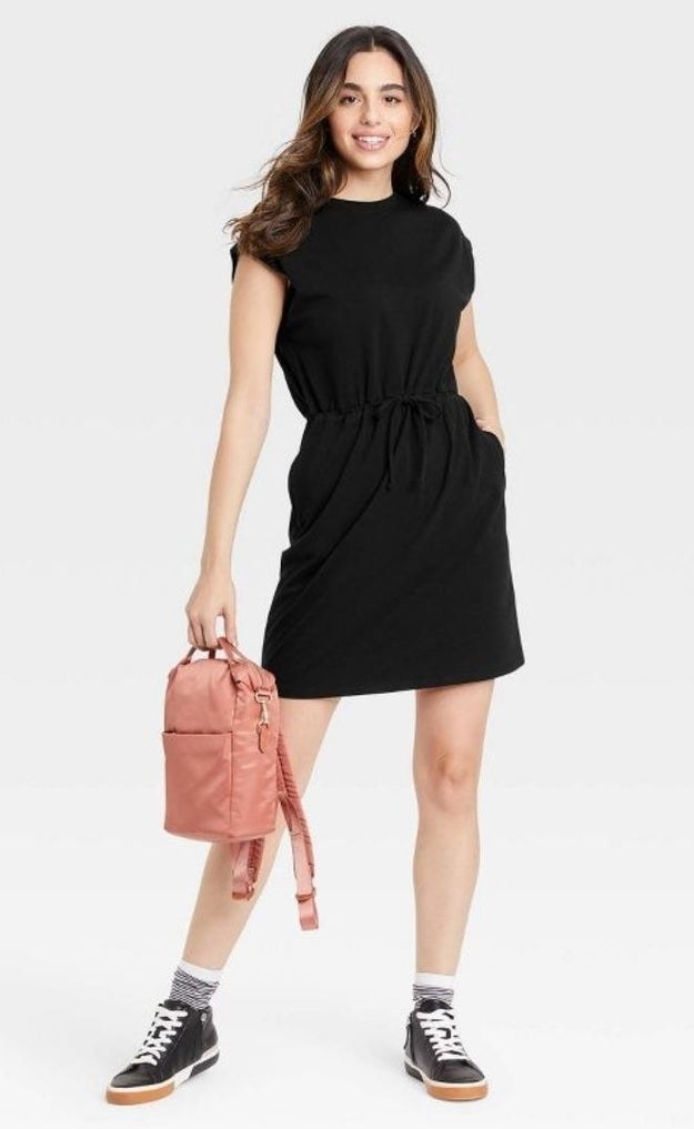 model wearing black sleeveless drawstring-waist dress