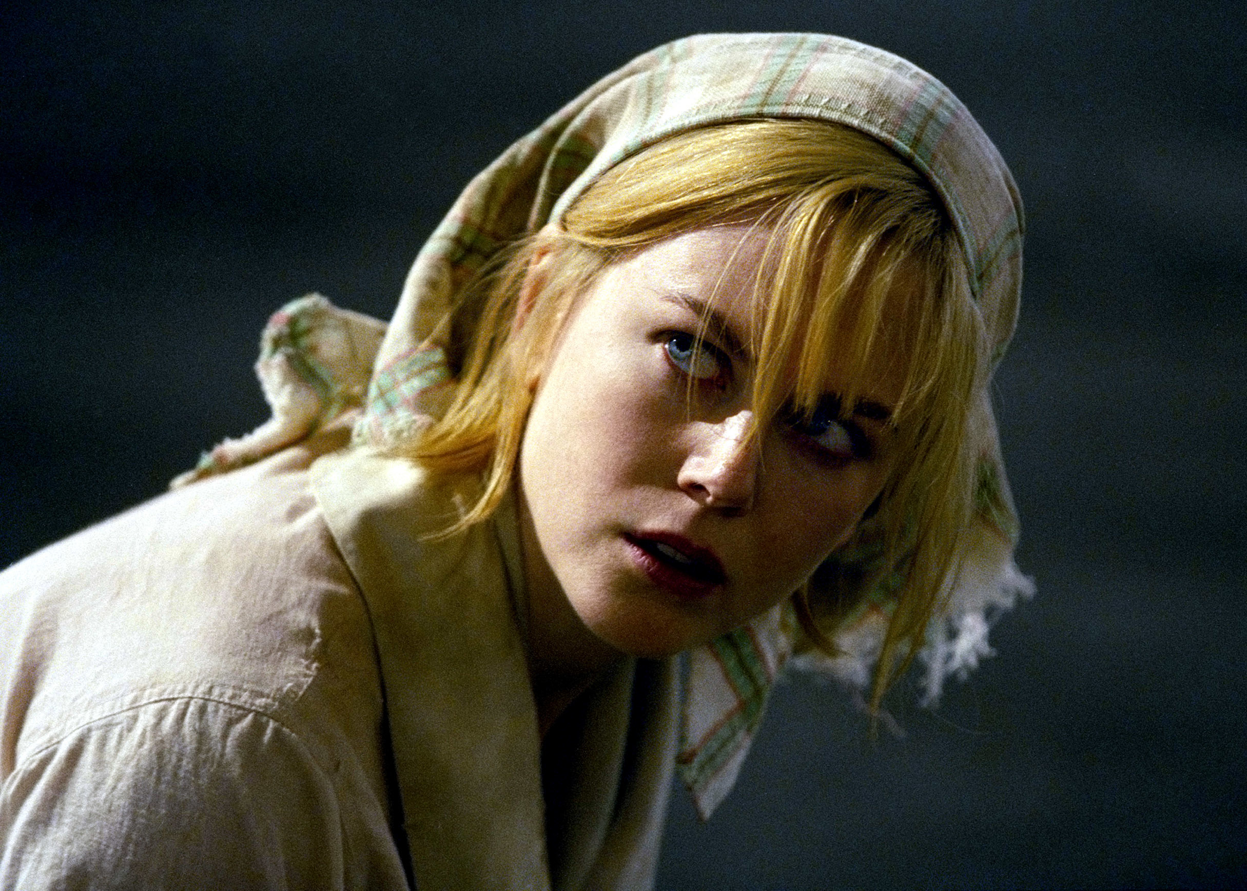 Nicole Kidman in raggedy clothes looking up in fear