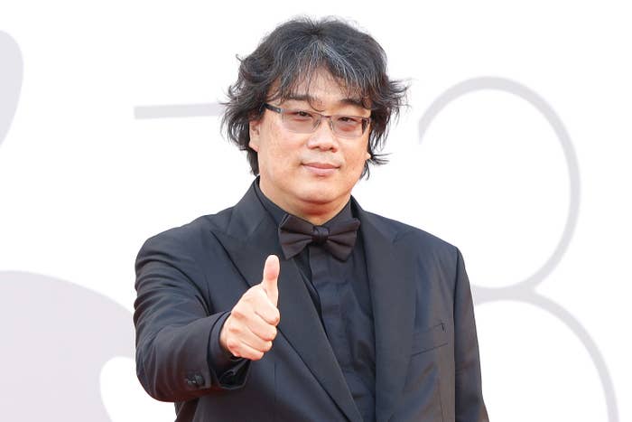 Bong Joon Ho at a film event, smiling with thumbs up
