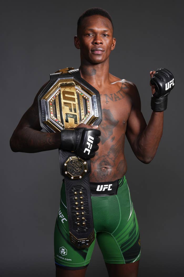 isreal posing with the ufc belt