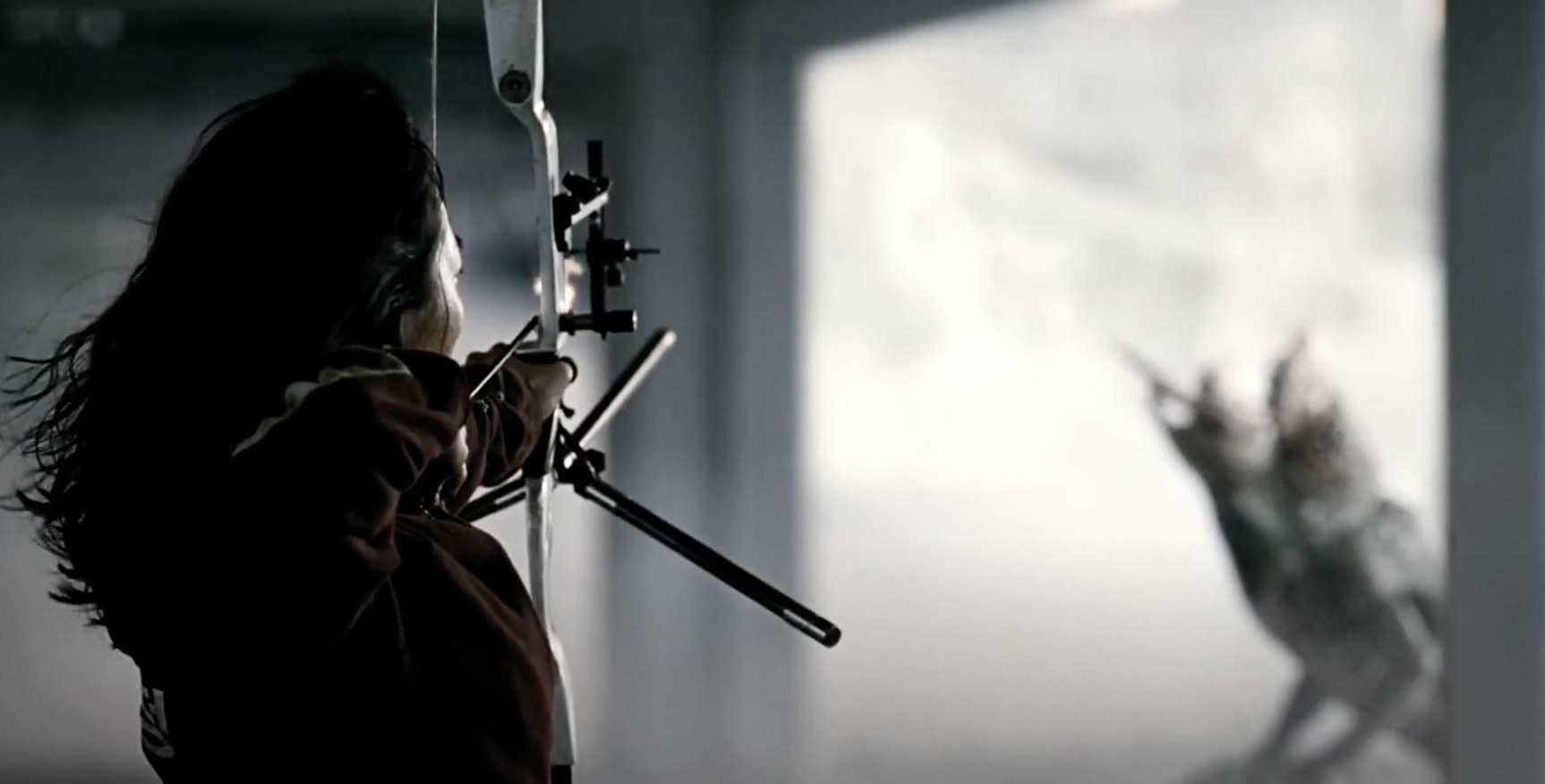 Bae Doona character aiming at the monster with bow and arrow in The Host
