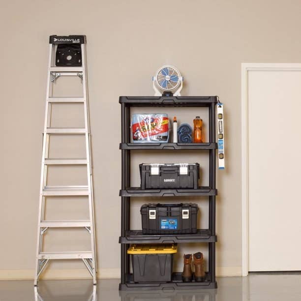 a black heavy-duty shelving unit holding heavy items